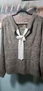 Pretty grey sweater with white tie up in the back.